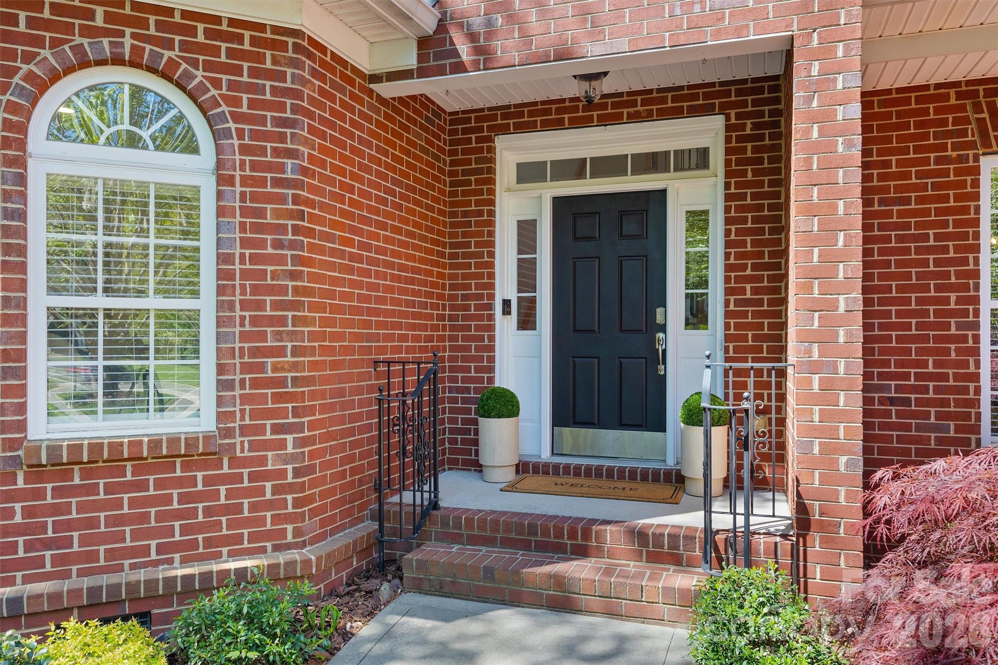 5103 Trinity Trace Lane Monroe, NC 28110 - Photo 3 of 48 a front view of a house with a garden