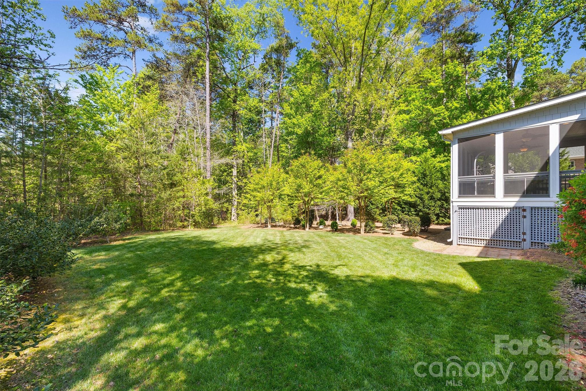 5103 Trinity Trace Lane Monroe, NC 28110 - Photo 45 of 48 a view of a backyard with table and chairs and large tree