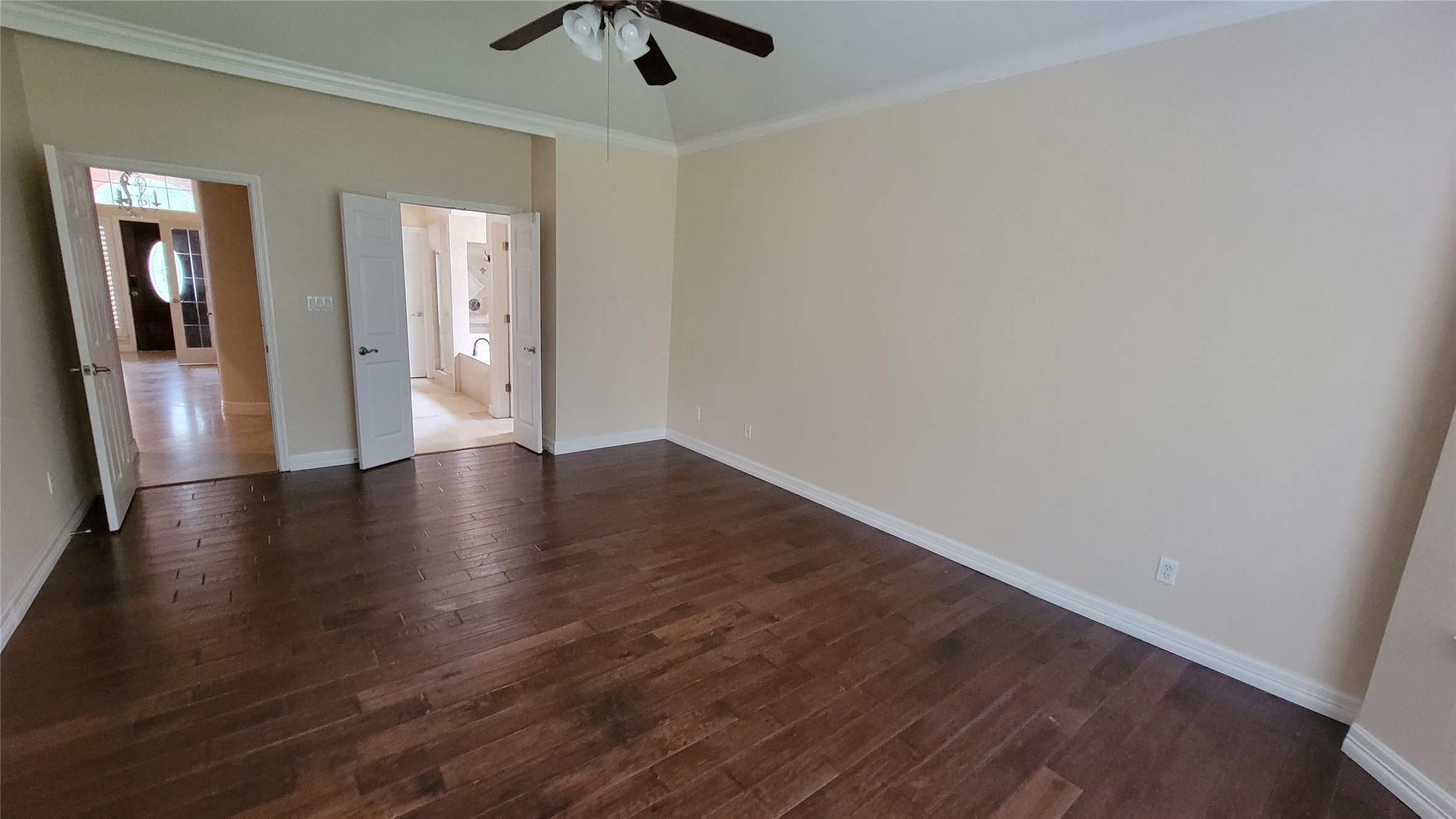 2832 Grimes Ranch Road Austin, TX 78732 - Photo 23 of 37 Rich hardwood floors flow through this generously sized room, offering a seamless transition to the adjoining bath.