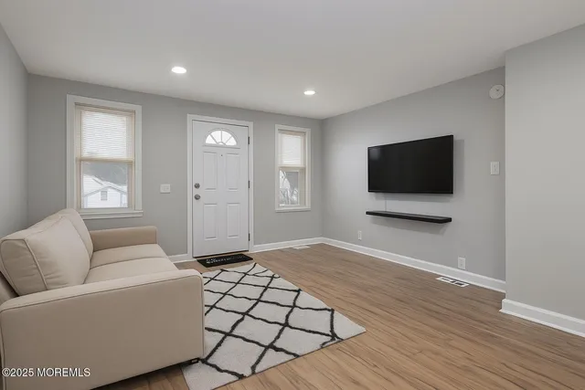 a view of empty room with wooden floor