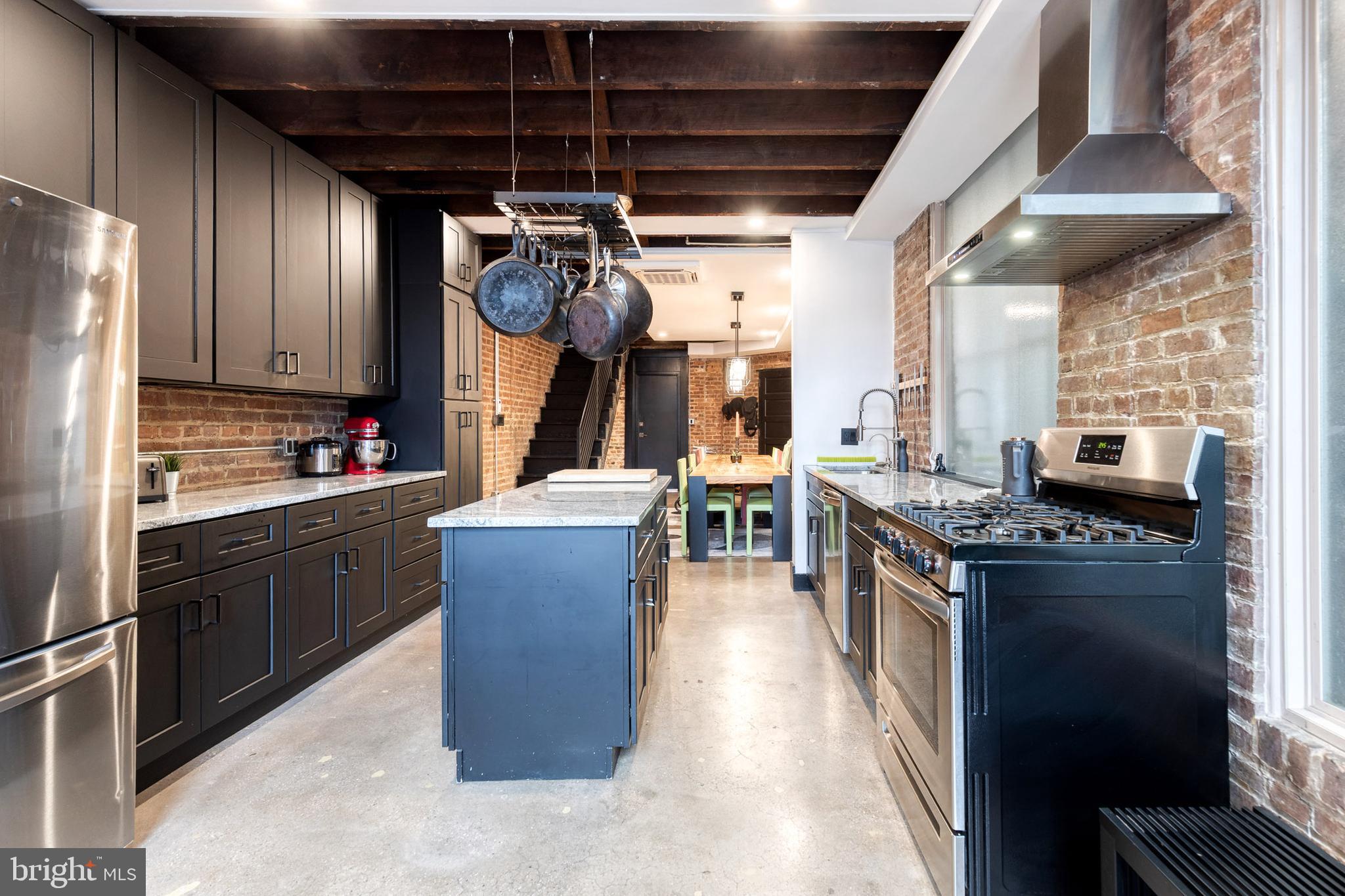 862 Tyson Street Baltimore, MD 21201 - Photo 21 of 62 a kitchen with stainless steel appliances granite countertop a stove a sink dishwasher and a refrigerator