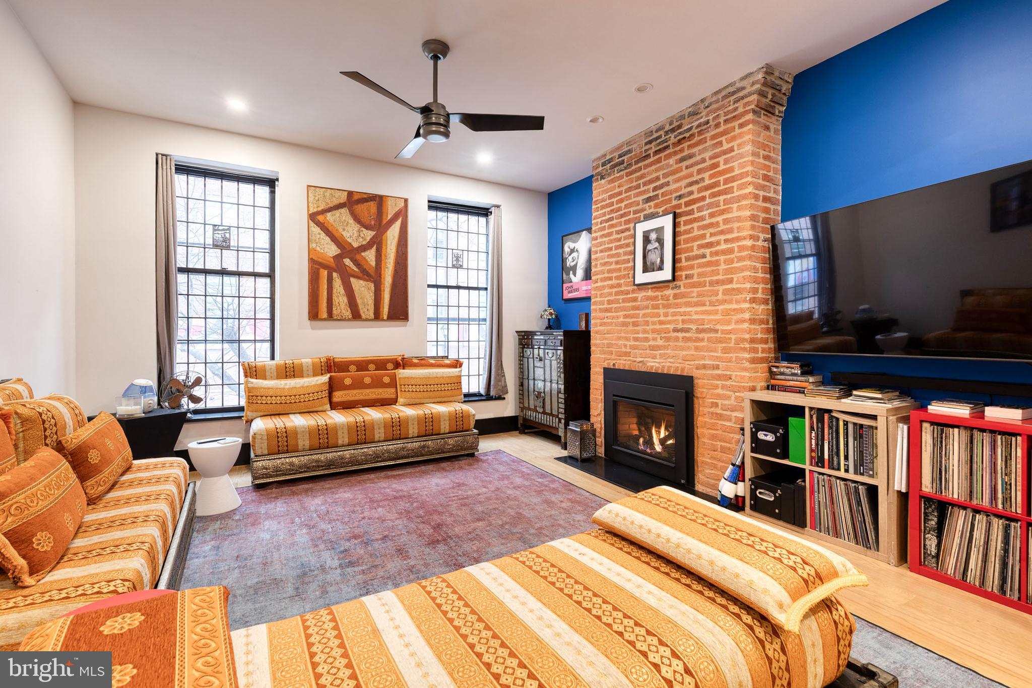 862 Tyson Street Baltimore, MD 21201 - Photo 23 of 62 a bedroom with furniture a flat screen tv and a fireplace