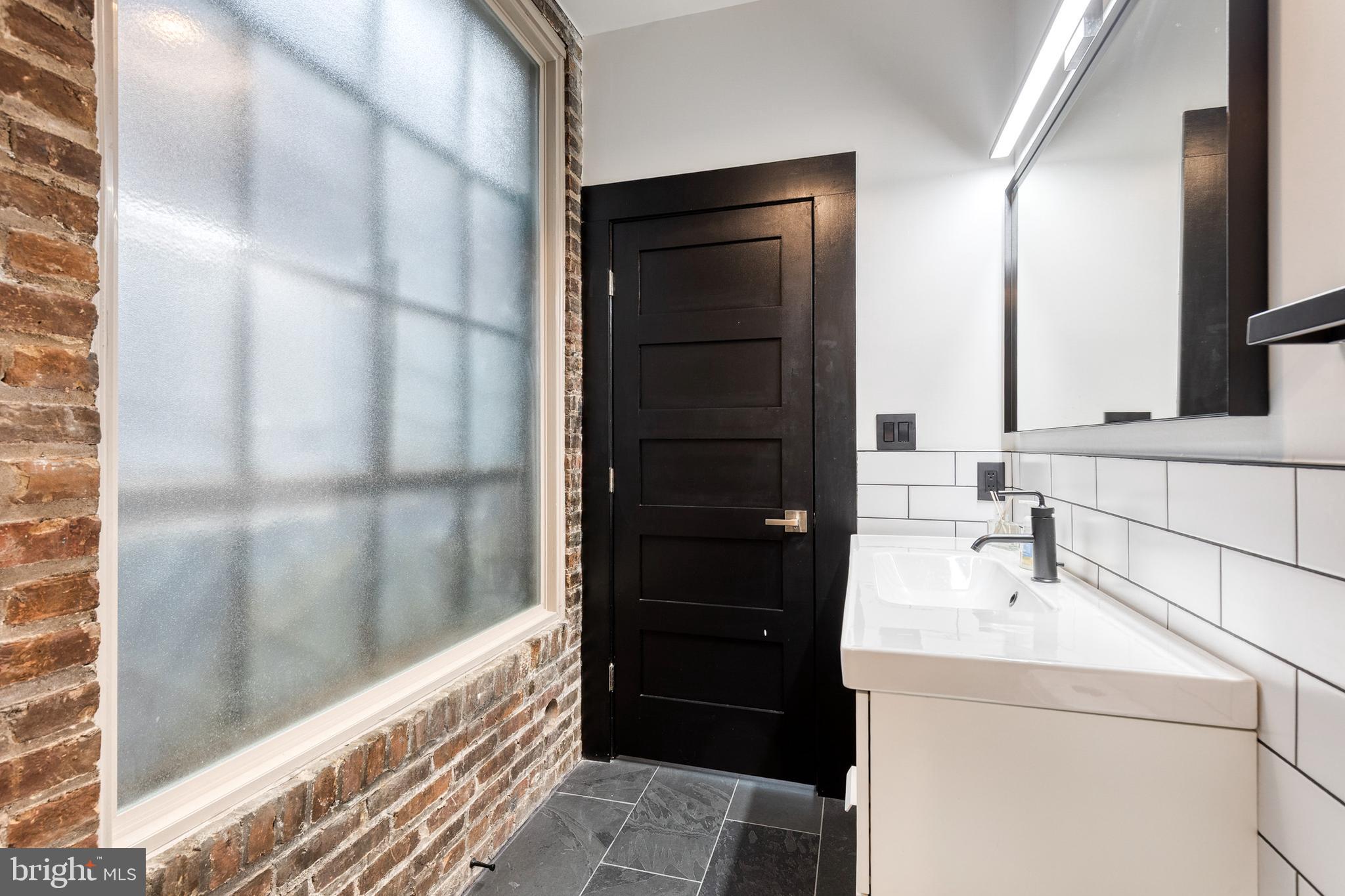862 Tyson Street Baltimore, MD 21201 - Photo 34 of 62 a bathroom with a sink and a mirror