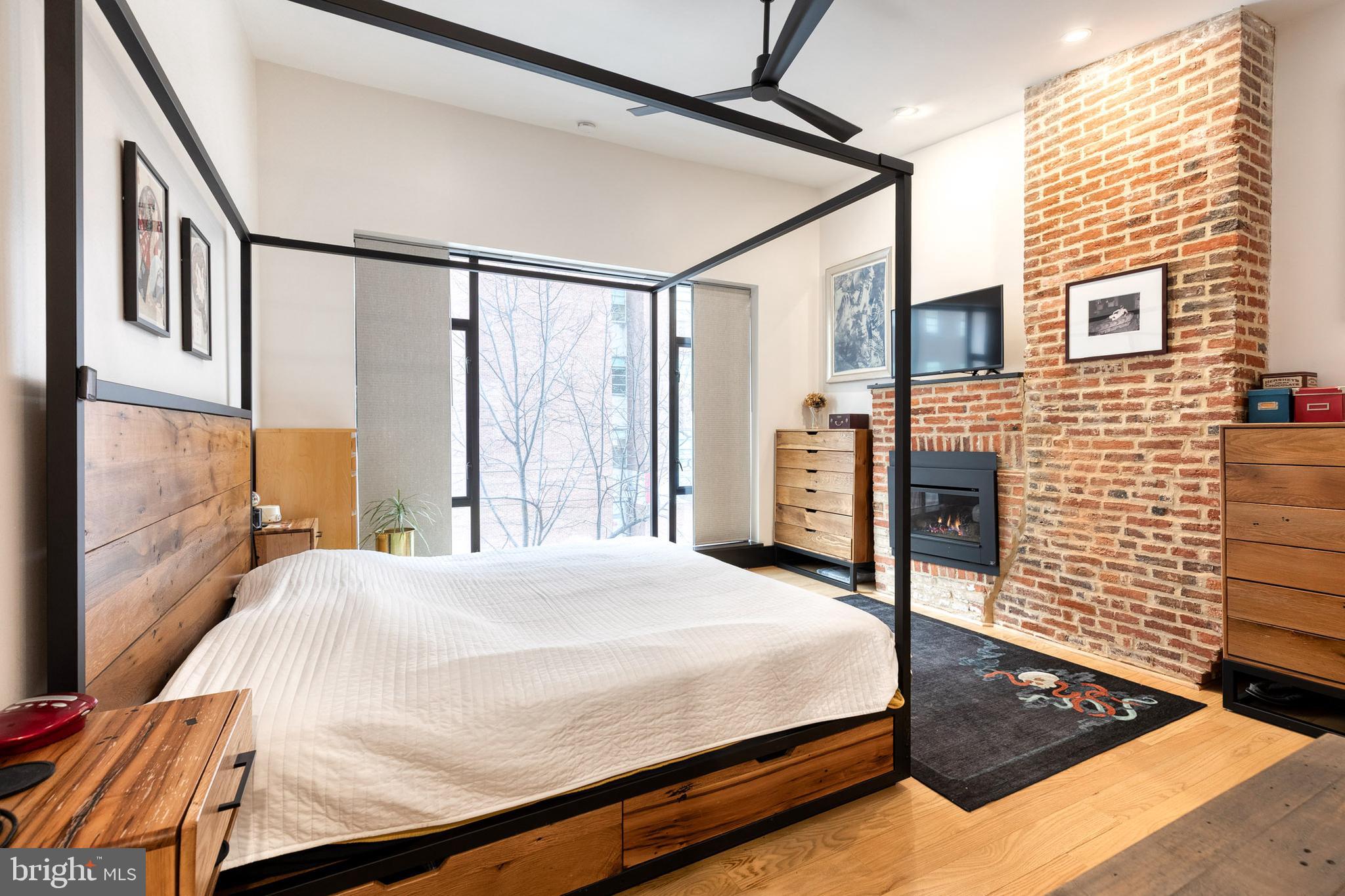 862 Tyson Street Baltimore, MD 21201 - Photo 40 of 62 a large bed sitting in a bedroom next to a window