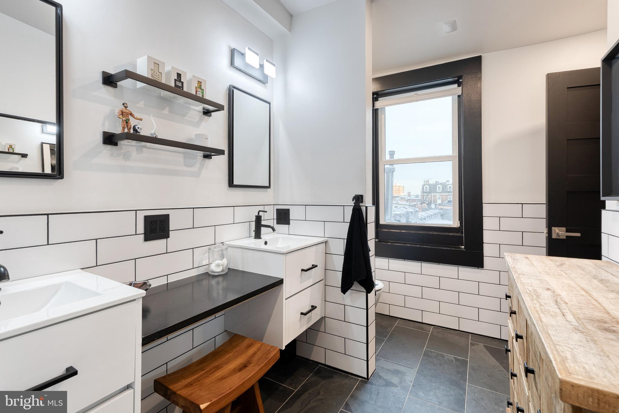 862 Tyson Street Baltimore, MD 21201 - Photo 45 of 62 a bathroom with a sink and a mirror