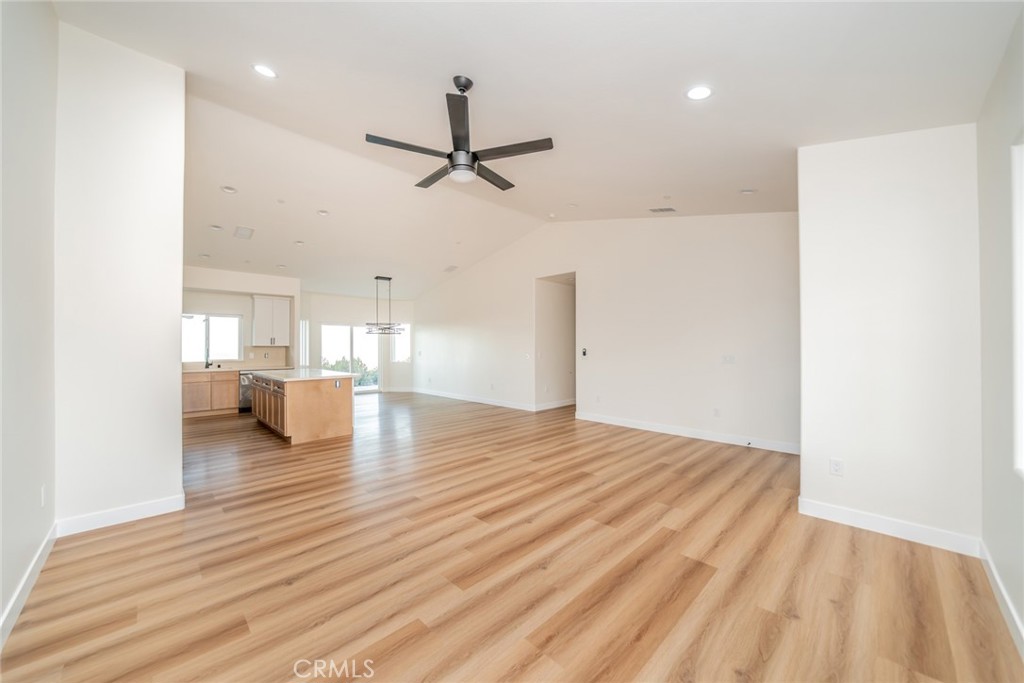 1114 Hollister Road Pinon Hills, CA 92372 - Photo 12 of 61 a view of empty room with wooden floor and windows