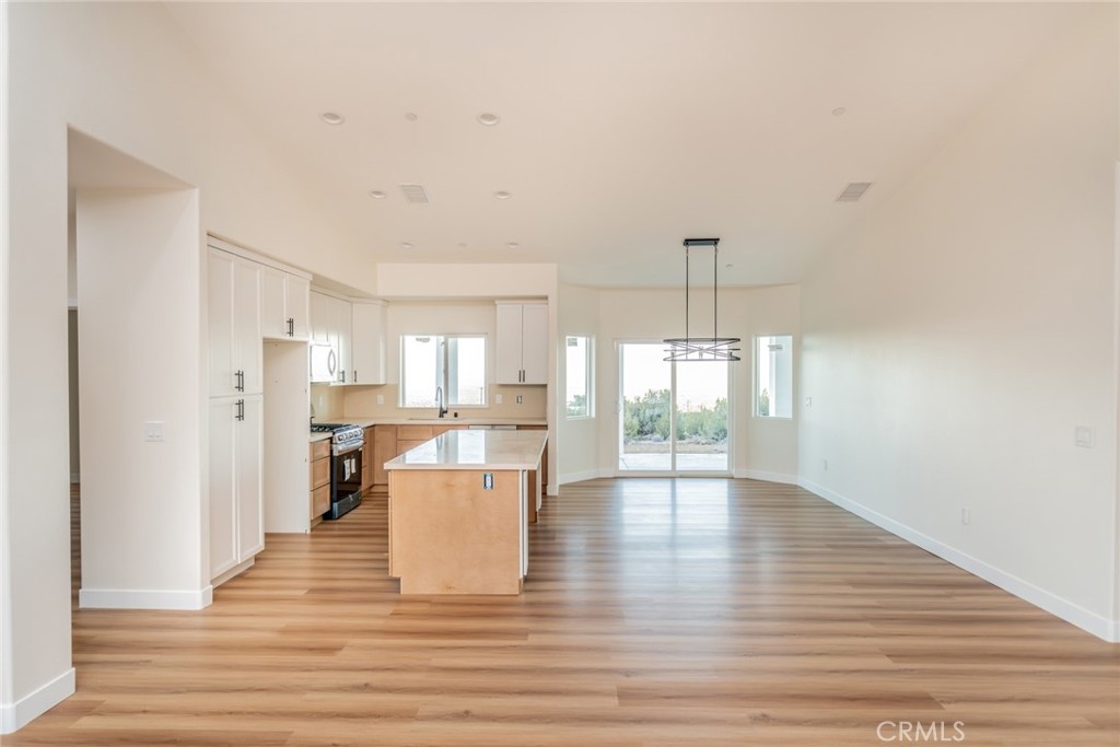 1114 Hollister Road Pinon Hills, CA 92372 - Photo 13 of 61 a view of open kitchen with furniture and wooden floor