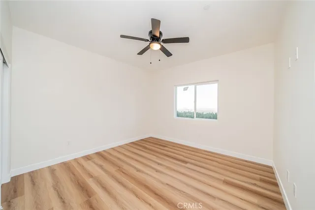 a bathroom with a bathtub shower sink vanity mirror and toilet