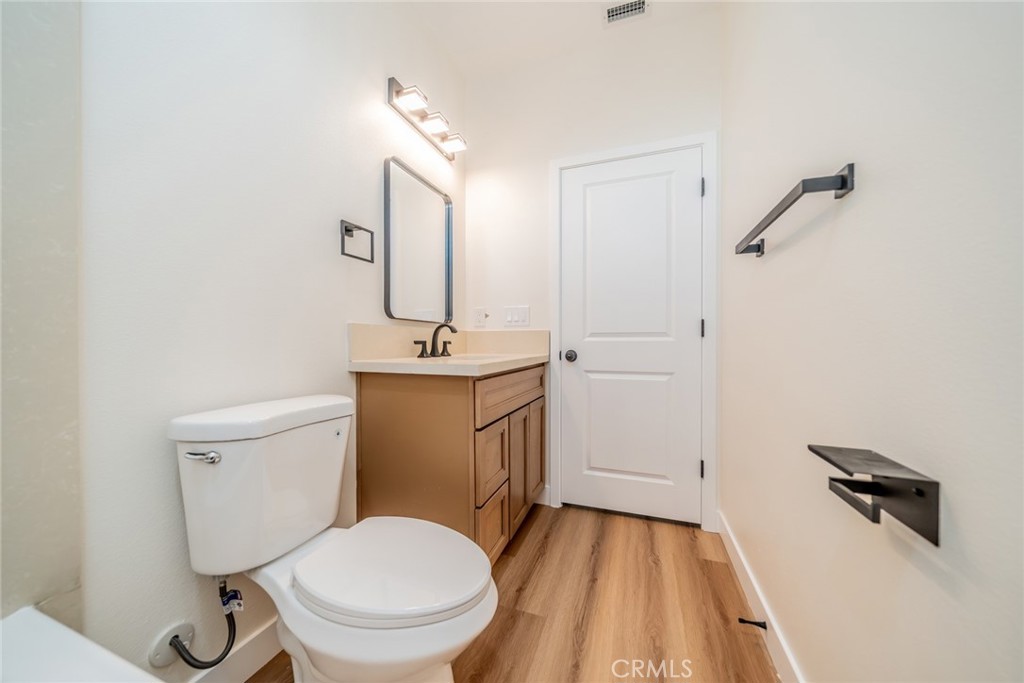 1114 Hollister Road Pinon Hills, CA 92372 - Photo 18 of 61 a bathroom with a toilet a sink and mirror
