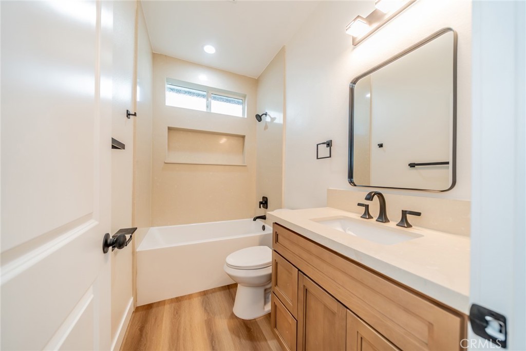 1114 Hollister Road Pinon Hills, CA 92372 - Photo 19 of 61 a bathroom with a bathtub shower sink vanity mirror and toilet