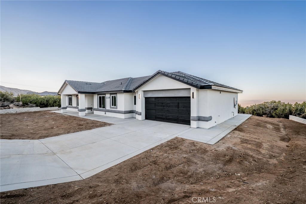 1114 Hollister Road Pinon Hills, CA 92372 - Photo 2 of 61 a front view of a house with a yard and garage