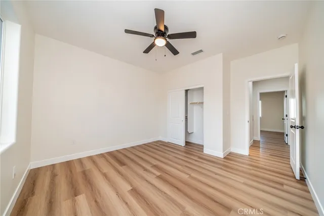 a view of a kitchen with wooden floor and electronic appliances