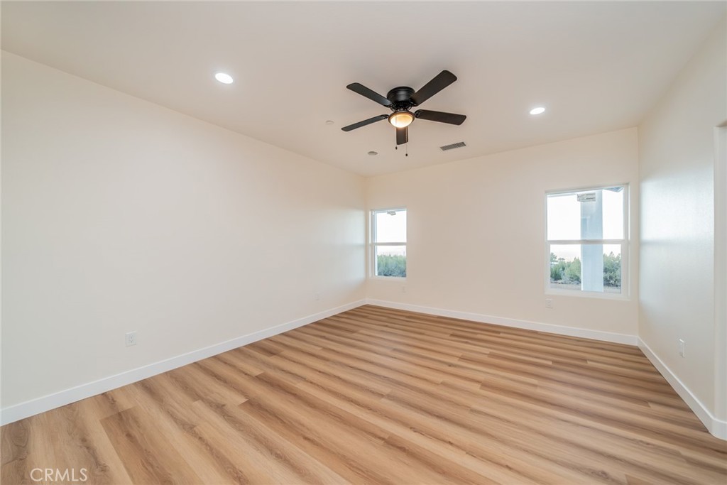 1114 Hollister Road Pinon Hills, CA 92372 - Photo 33 of 61 a view of empty room with wooden floor and fan