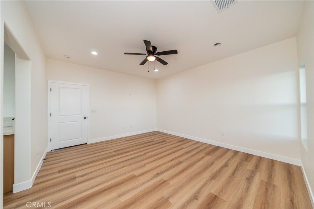 1114 Hollister Road Pinon Hills, CA 92372 - Photo 35 of 61 wooden floor in an empty room with a window