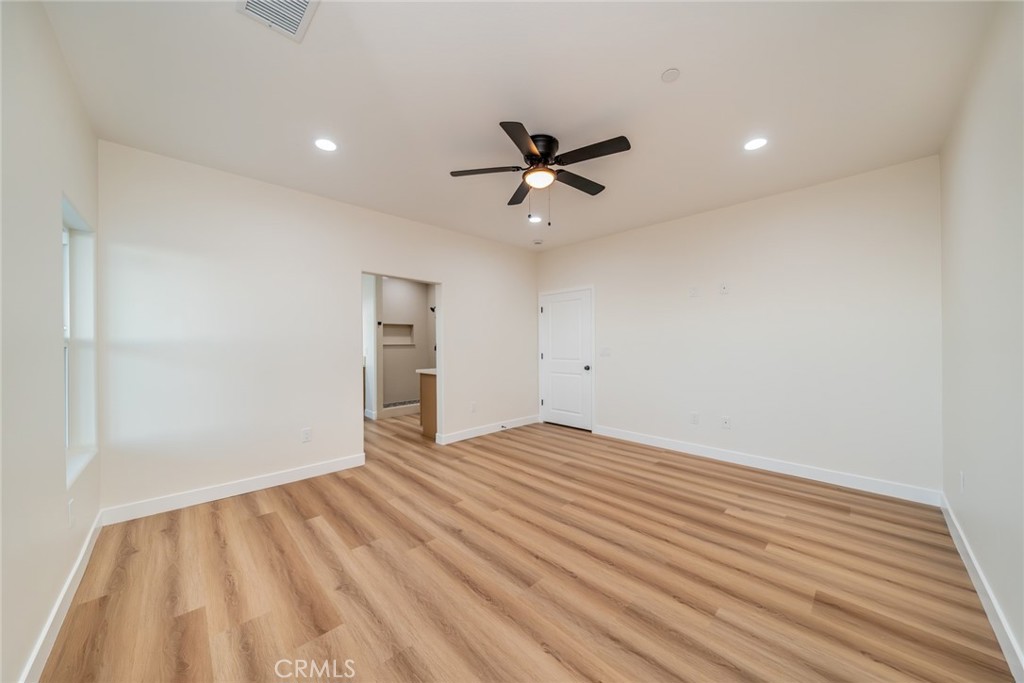 1114 Hollister Road Pinon Hills, CA 92372 - Photo 36 of 61 a view of empty room with wooden floor and fan