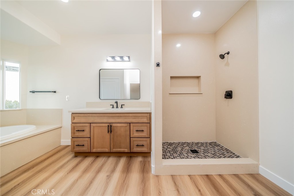 1114 Hollister Road Pinon Hills, CA 92372 - Photo 38 of 61 a bathroom with a sink a mirror and a bathtub