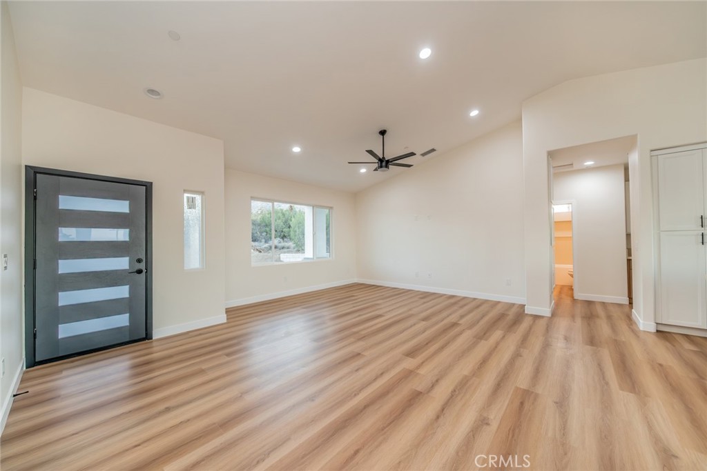 1114 Hollister Road Pinon Hills, CA 92372 - Photo 4 of 61 wooden floor in an empty room with a window