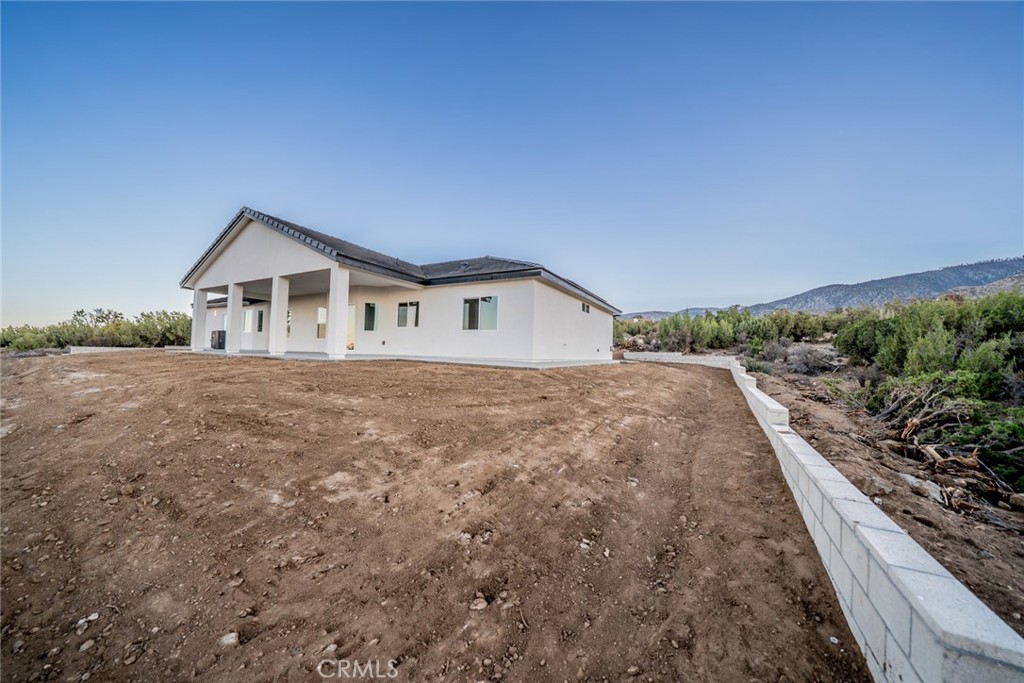 1114 Hollister Road Pinon Hills, CA 92372 - Photo 48 of 61 a house with trees in the background