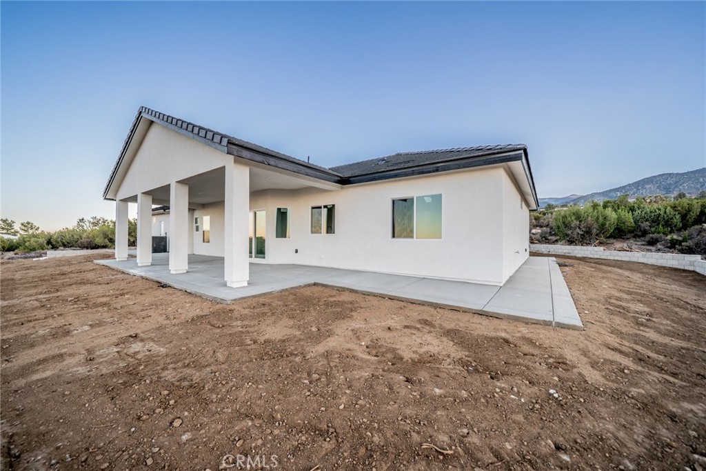 1114 Hollister Road Pinon Hills, CA 92372 - Photo 49 of 61 a view of a house with a backyard
