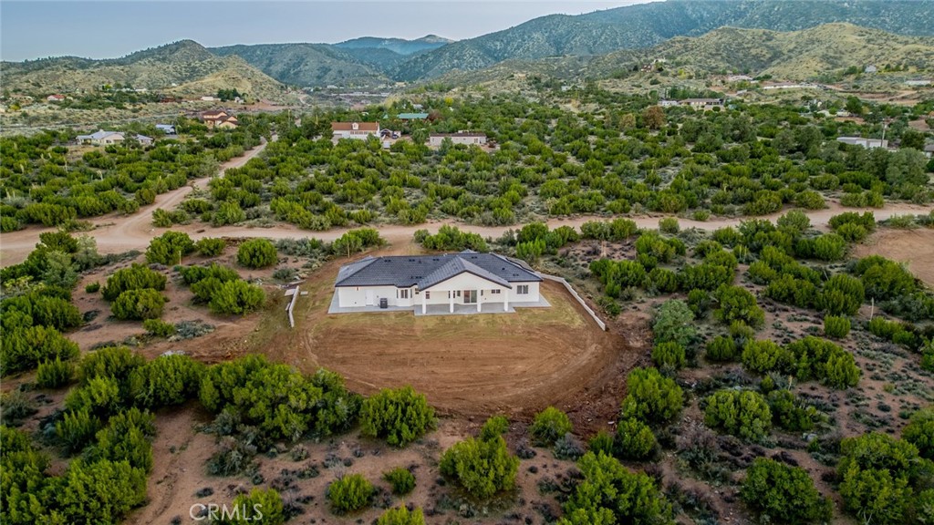 1114 Hollister Road Pinon Hills, CA 92372 - Photo 57 of 61 an aerial view of a house with a yard and large tree