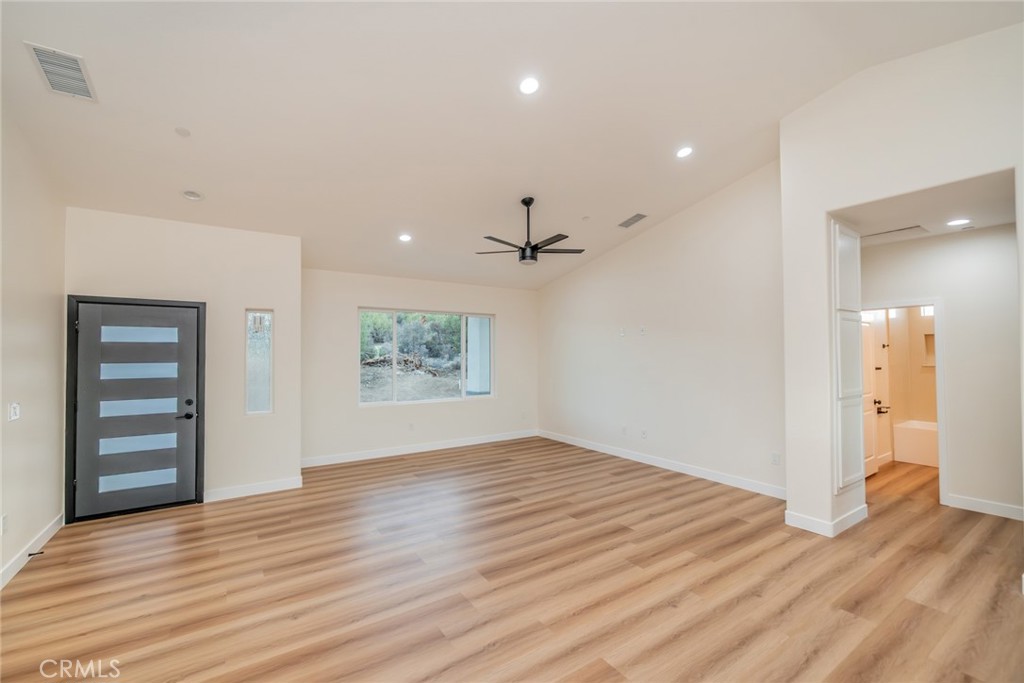 1114 Hollister Road Pinon Hills, CA 92372 - Photo 6 of 61 wooden floor in an empty room with a window