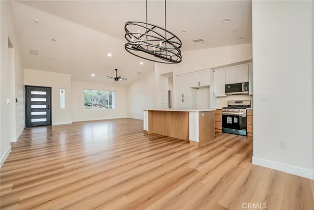 a view of empty room with wooden floor and windows