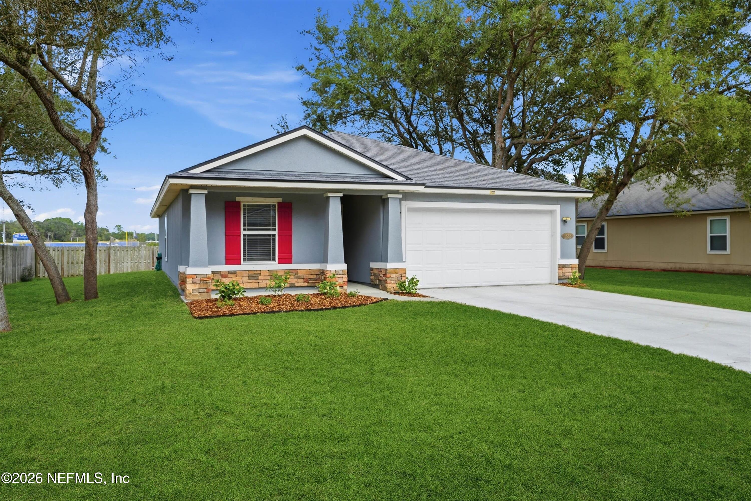 a front view of house with yard and outdoor seating