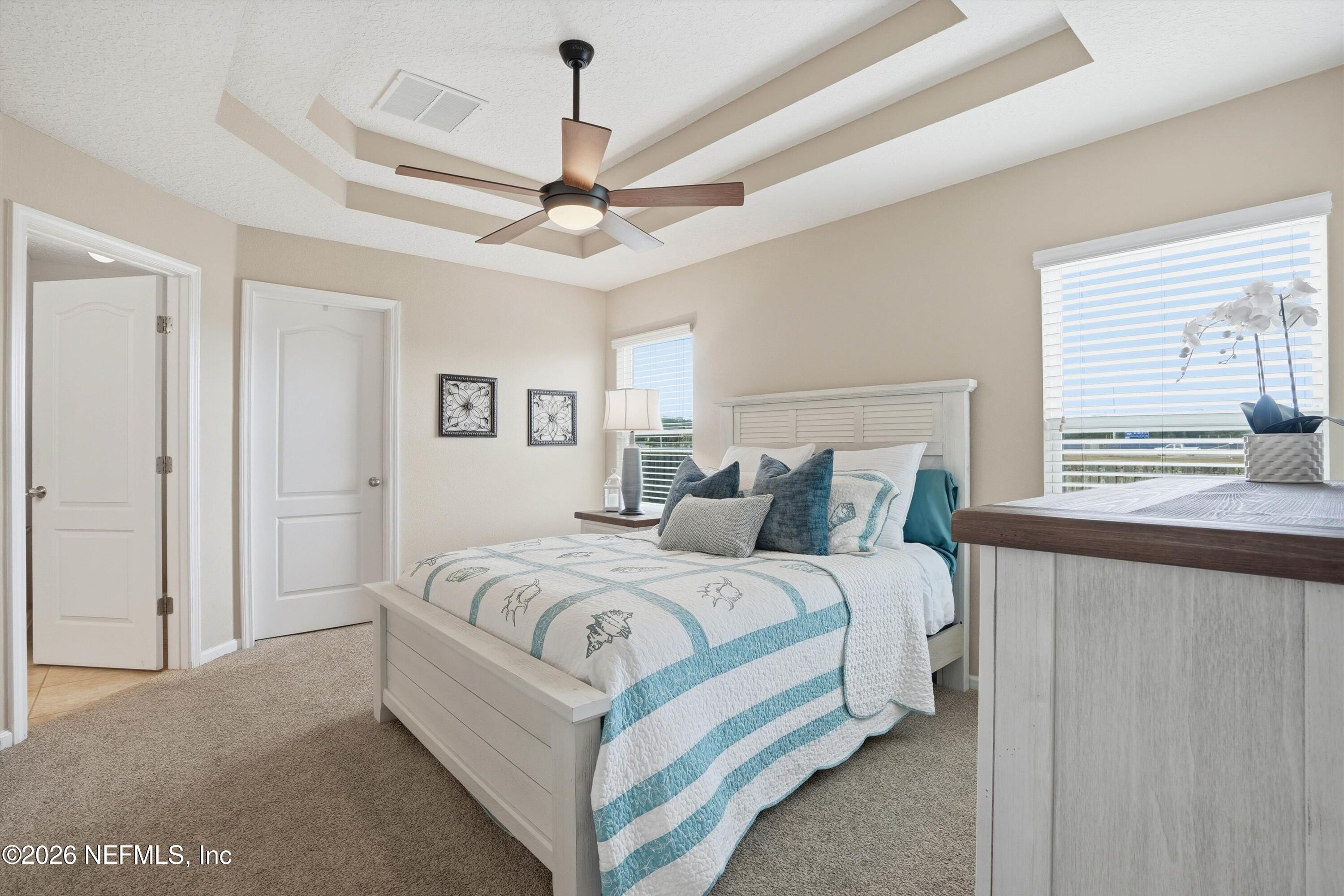 1833 Indigo Street Fernandina Beach, FL 32034 - Photo 17 of 41 a bed room with a bed and a ceiling fan