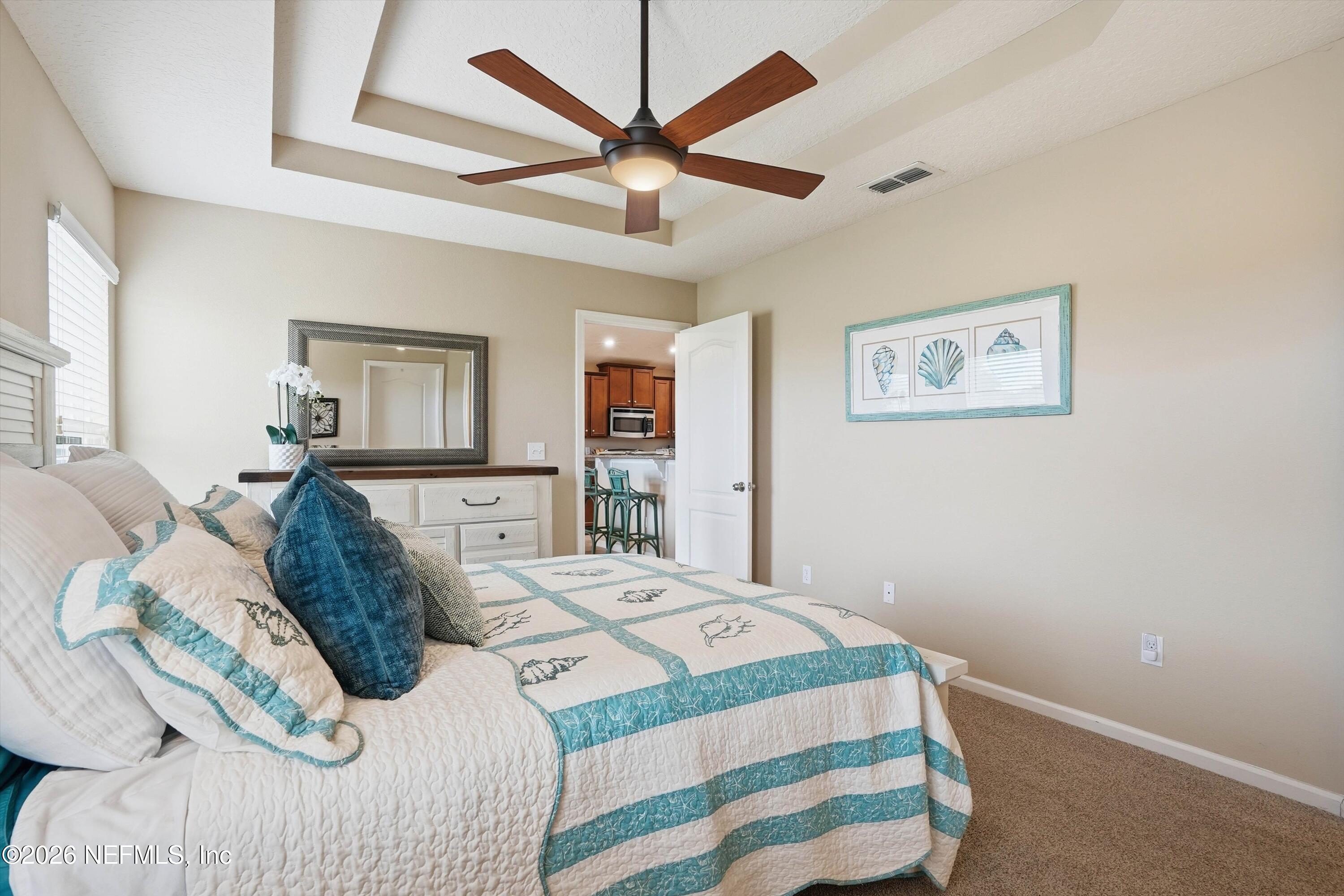 1833 Indigo Street Fernandina Beach, FL 32034 - Photo 18 of 41 a bedroom with a large bed and a chandelier