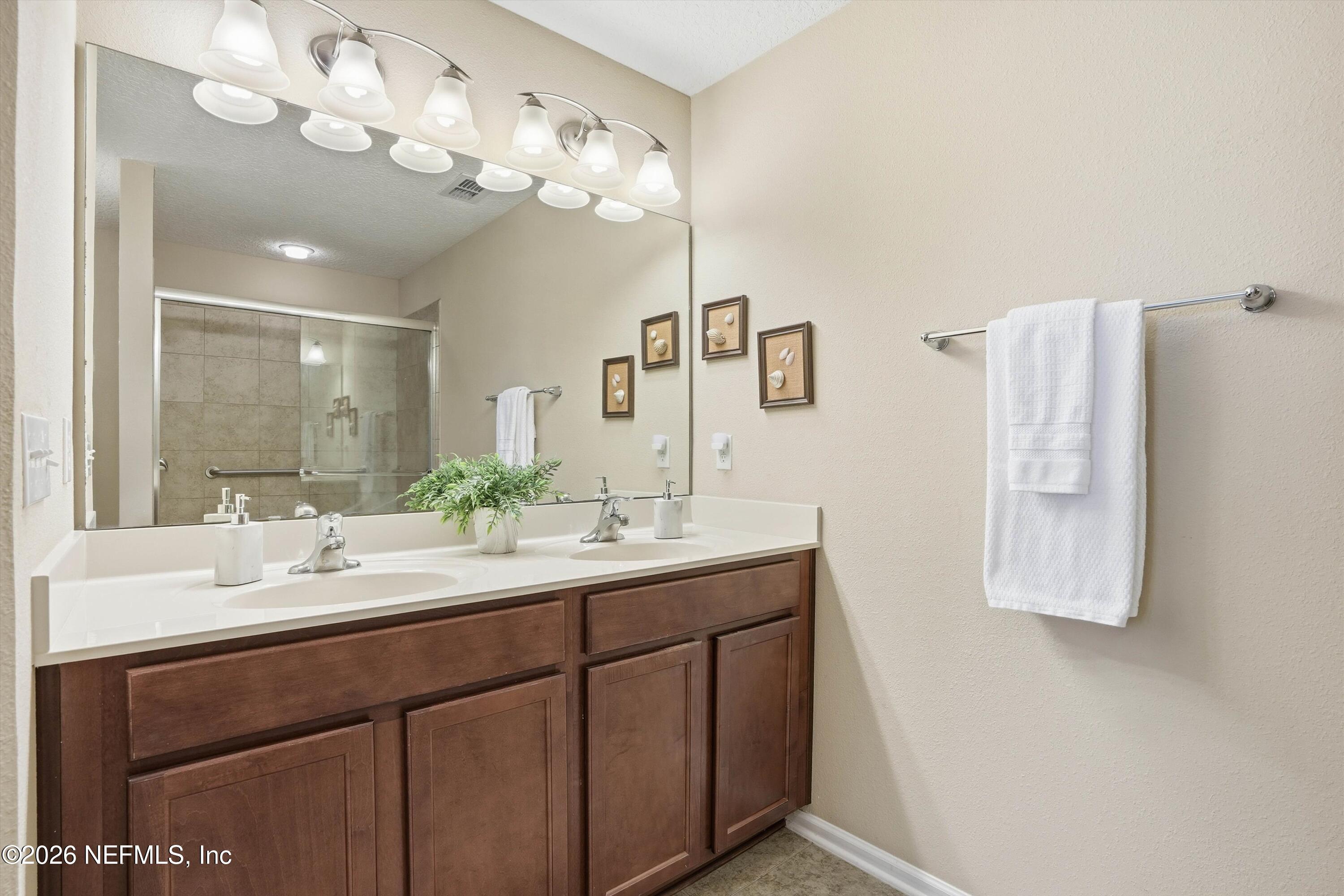 1833 Indigo Street Fernandina Beach, FL 32034 - Photo 19 of 41 a bathroom with a sink vanity and mirror