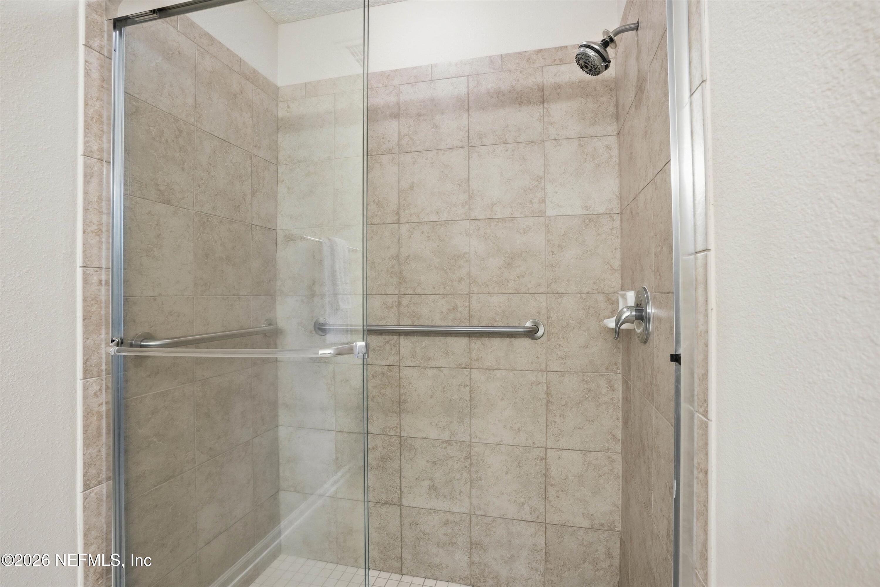 1833 Indigo Street Fernandina Beach, FL 32034 - Photo 20 of 41 a bathroom with a glass shower door