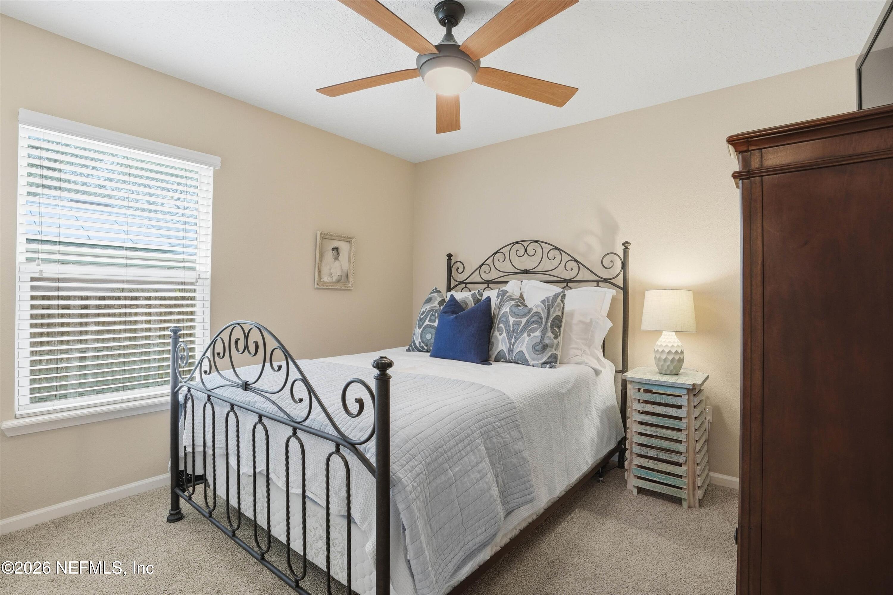 1833 Indigo Street Fernandina Beach, FL 32034 - Photo 21 of 41 a bedroom with a bed and a chandelier