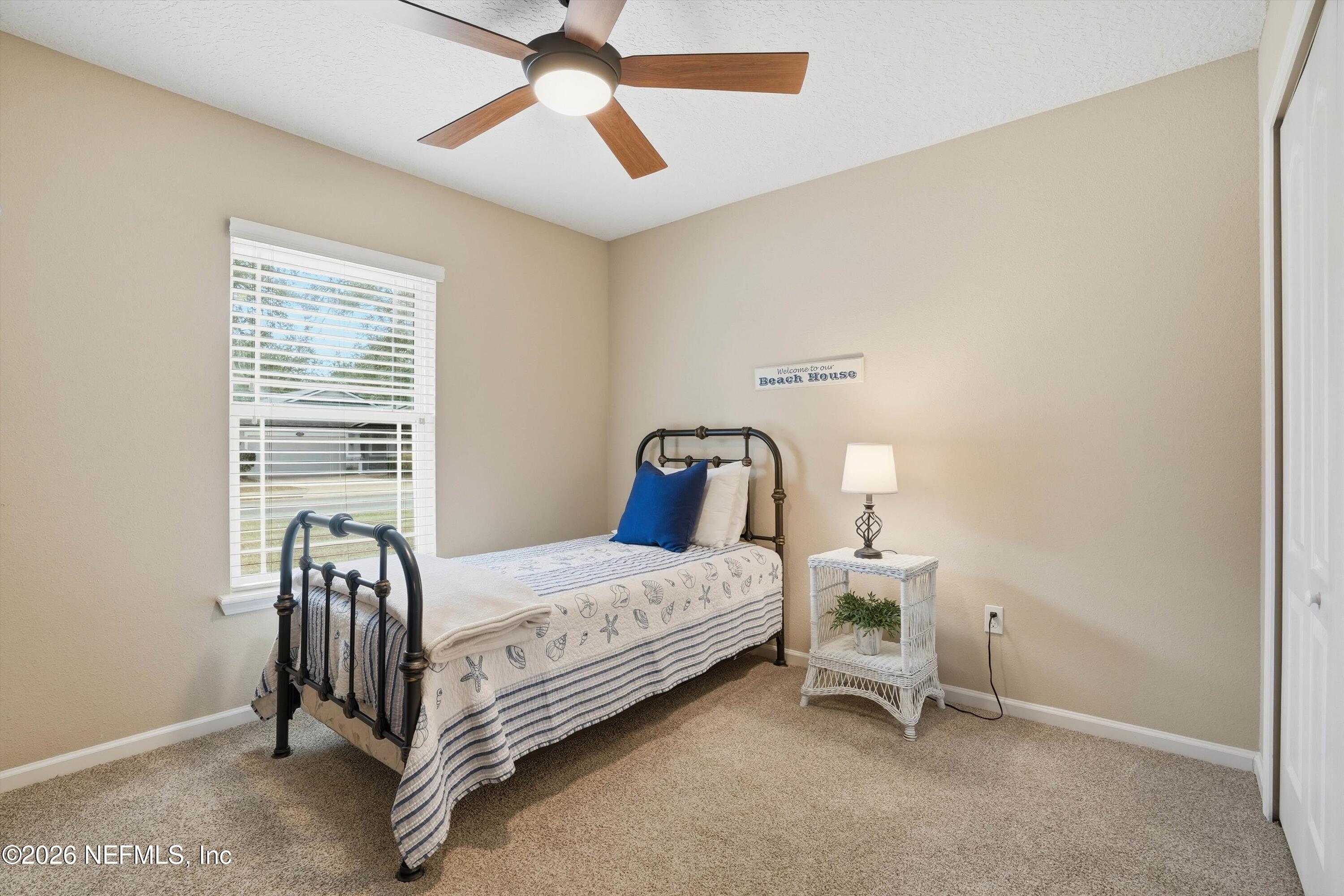 1833 Indigo Street Fernandina Beach, FL 32034 - Photo 23 of 41 a bedroom with a bed chair and a window