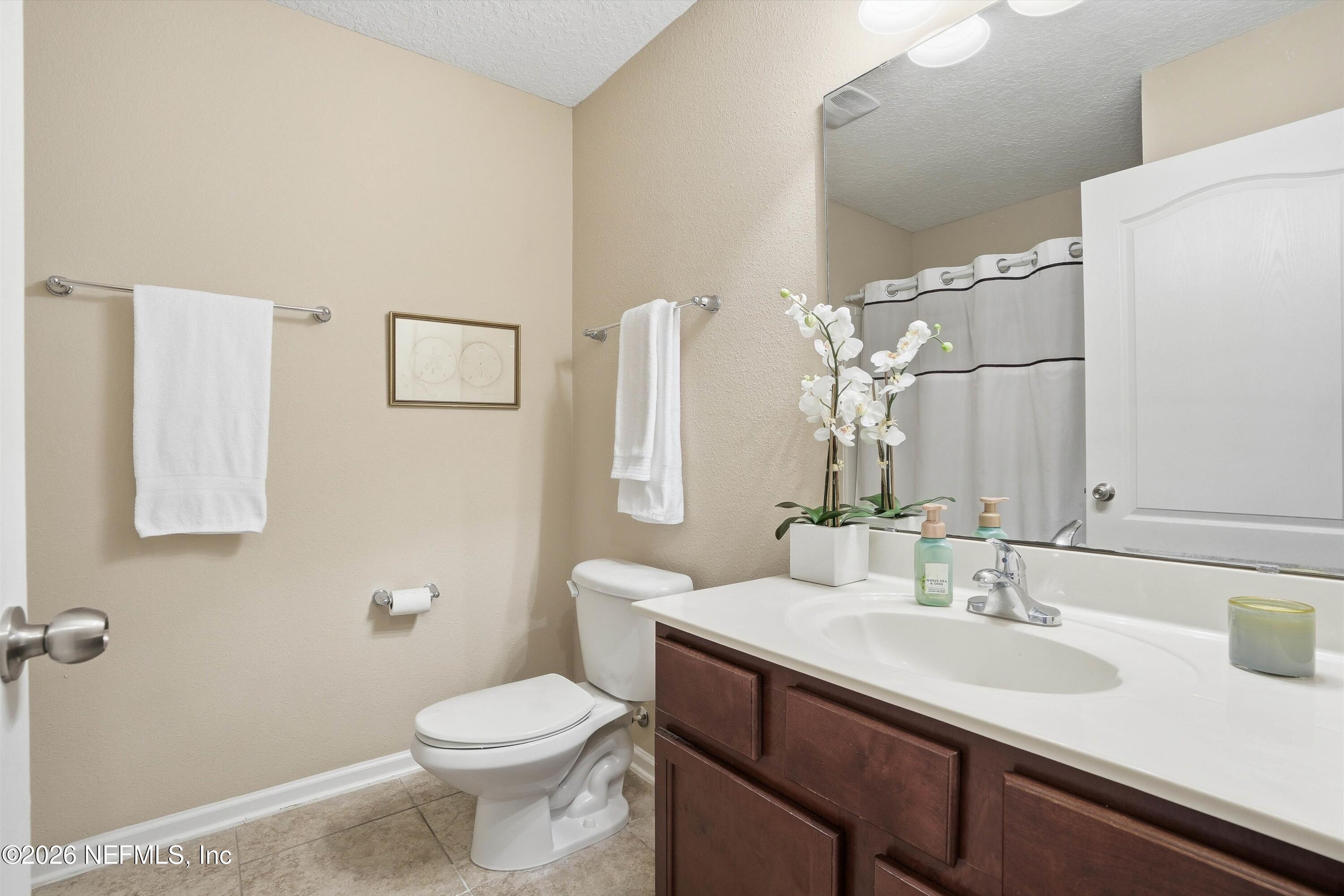 1833 Indigo Street Fernandina Beach, FL 32034 - Photo 25 of 41 a bathroom with a sink a toilet and mirror