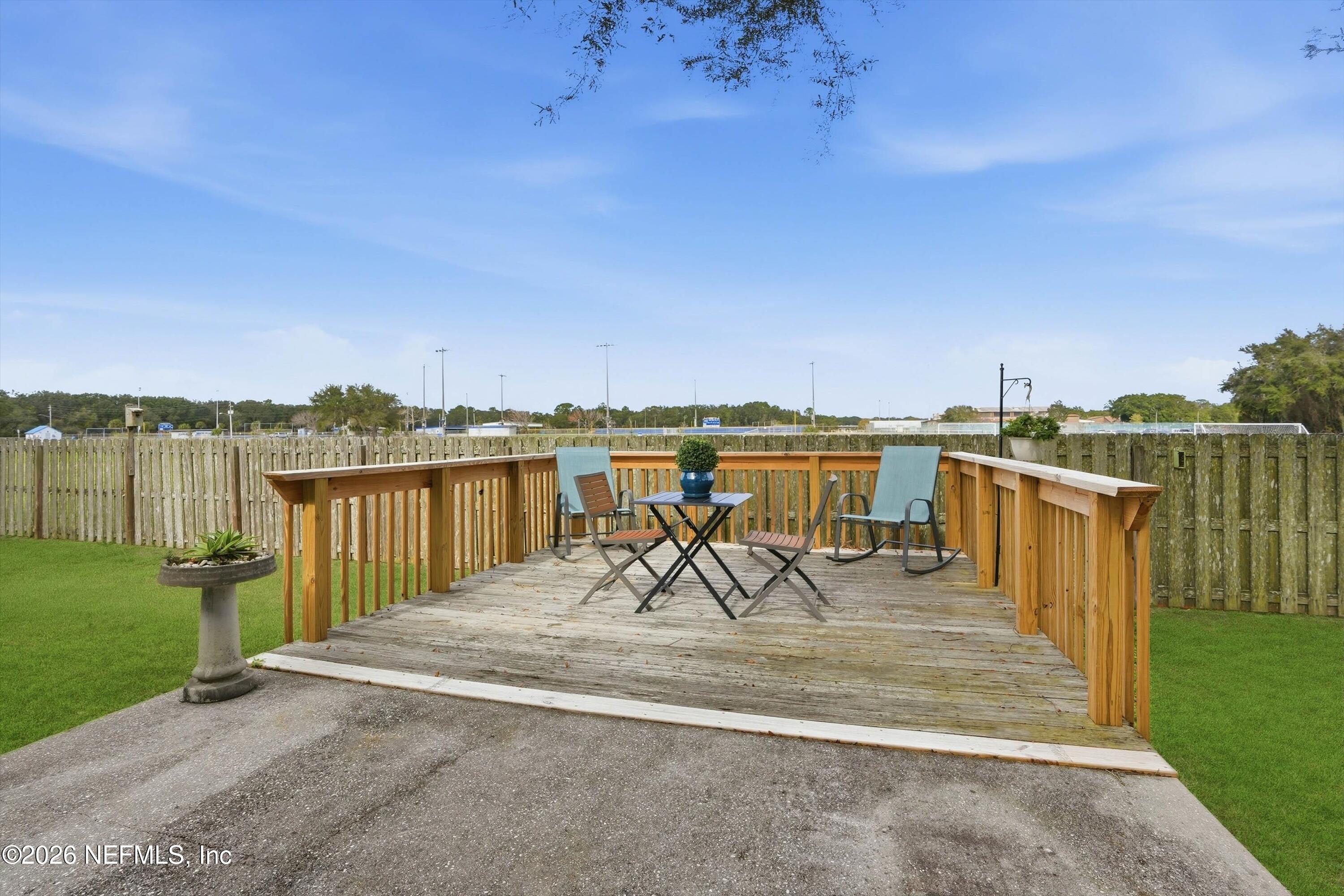 1833 Indigo Street Fernandina Beach, FL 32034 - Photo 26 of 41 a view of a lake with a table and chairs with wooden floor and fence