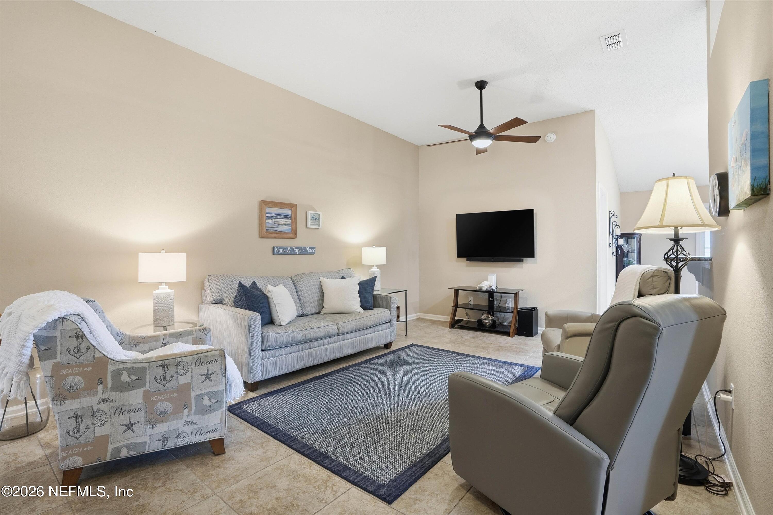 1833 Indigo Street Fernandina Beach, FL 32034 - Photo 5 of 41 a living room with furniture a flat screen tv and a lamp