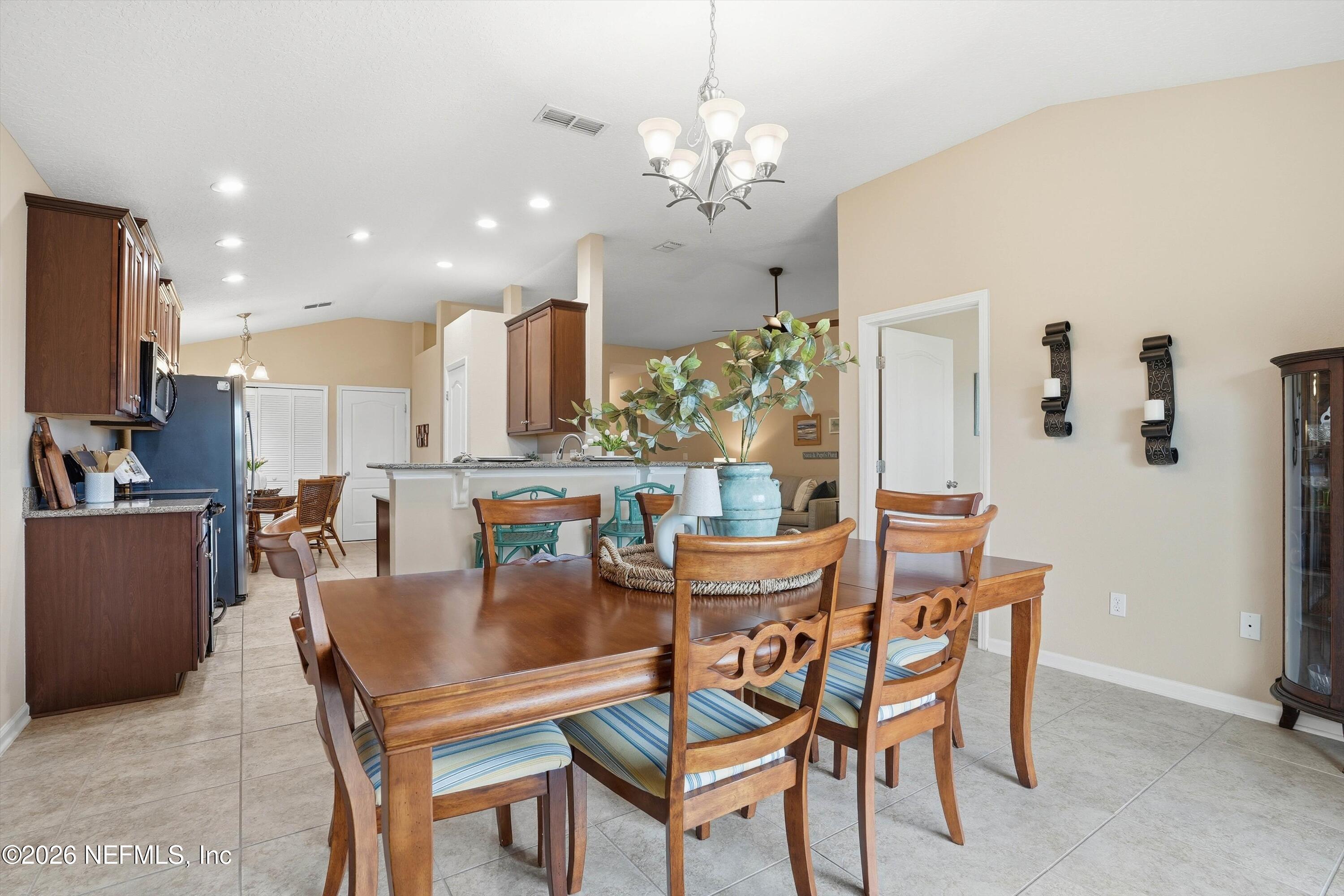 1833 Indigo Street Fernandina Beach, FL 32034 - Photo 9 of 41 a dining room with furniture a chandelier and kitchen view