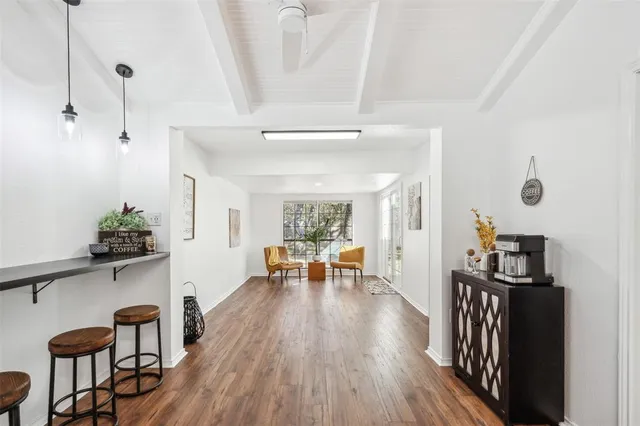 a view of a room with furniture and wooden floor