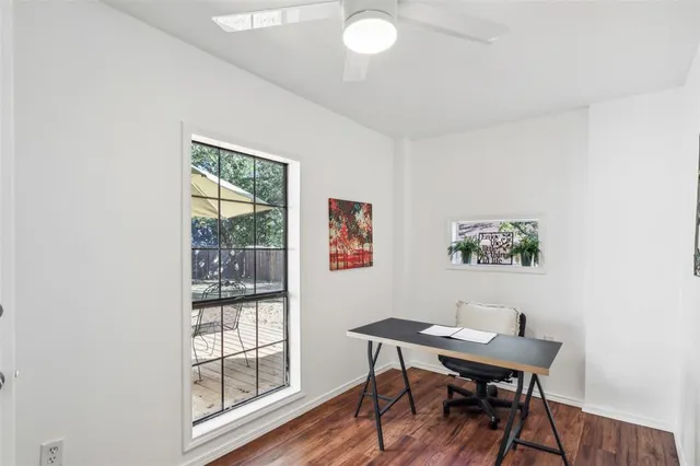 a view of a workspace with furniture and wooden floor