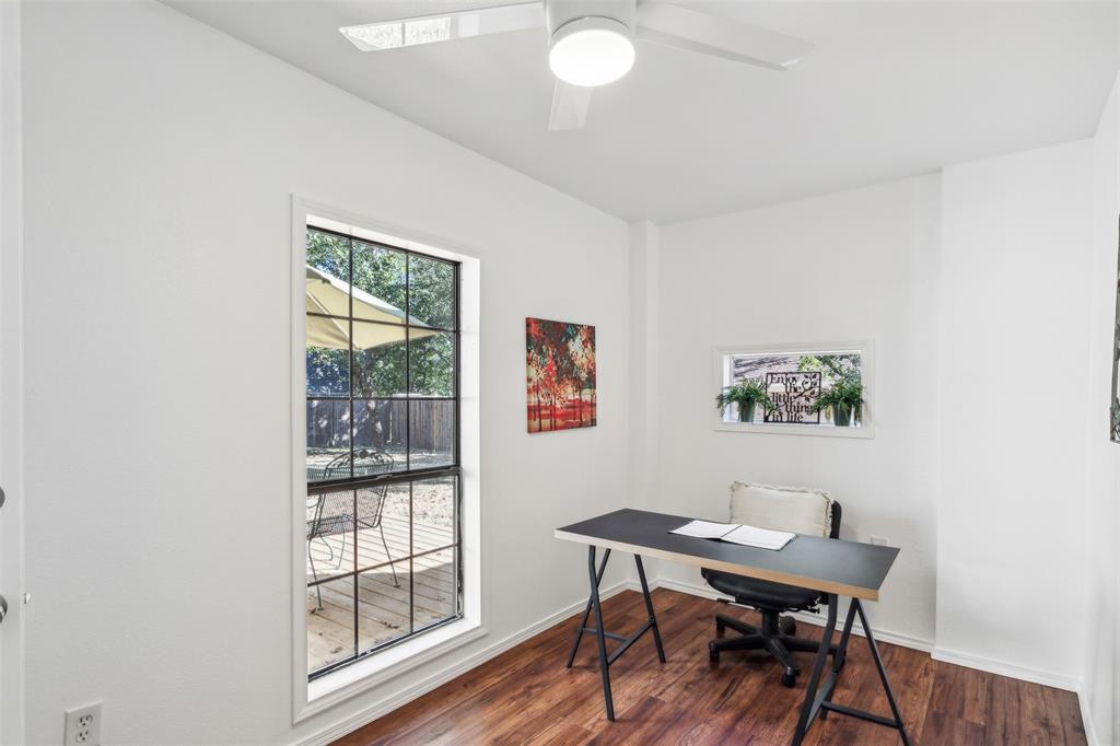 215 Shady Oak Road Keene, TX 76059 - Photo 15 of 26 a view of a workspace with furniture and wooden floor