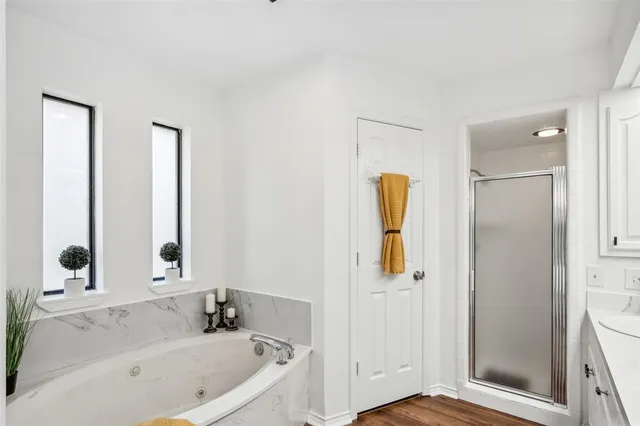 a bathroom with a tub and a window