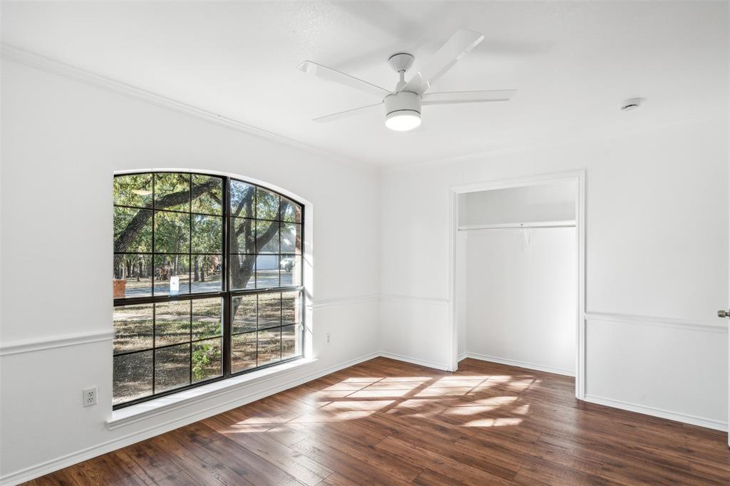 215 Shady Oak Road Keene, TX 76059 - Photo 20 of 26 a view of an empty room with a window and wooden floor