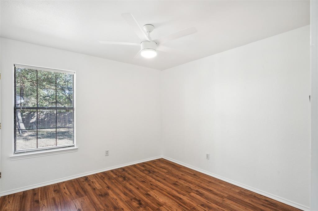 215 Shady Oak Road Keene, TX 76059 - Photo 21 of 26 an empty room with a window and a fan