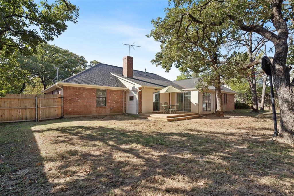 215 Shady Oak Road Keene, TX 76059 - Photo 24 of 26 a front view of a house with a yard