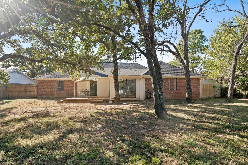 215 Shady Oak Road Keene, TX 76059 - Photo 25 of 26 a yard that has a large tree in front of it