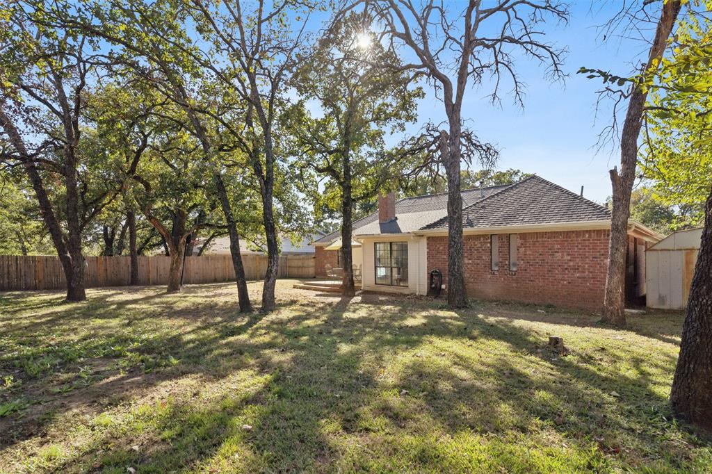 215 Shady Oak Road Keene, TX 76059 - Photo 26 of 26 a view of a yard with a large tree