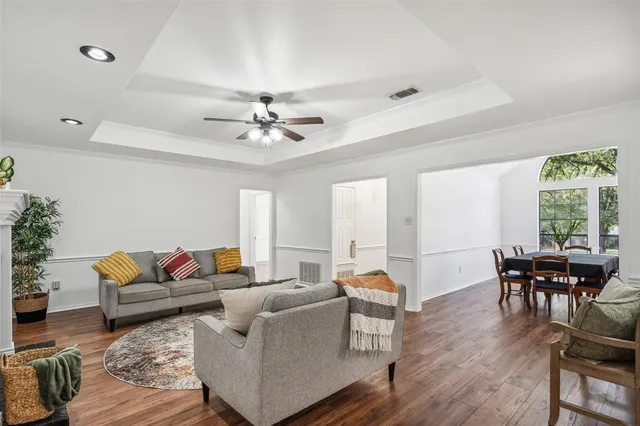 a living room with furniture and wooden floor