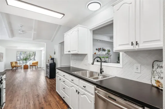 a kitchen with sink refrigerator and cabinets