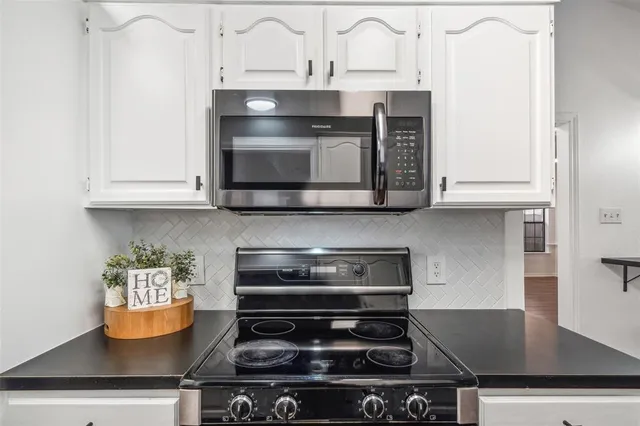 a stove top oven sitting inside of a kitchen