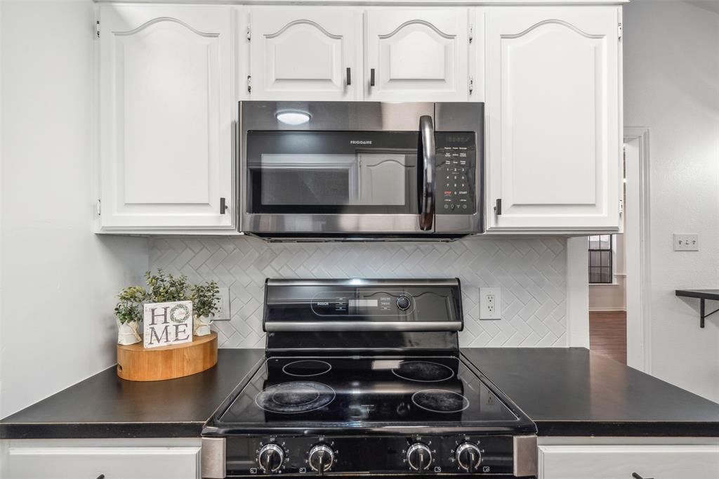 215 Shady Oak Road Keene, TX 76059 - Photo 10 of 26 a stove top oven sitting inside of a kitchen